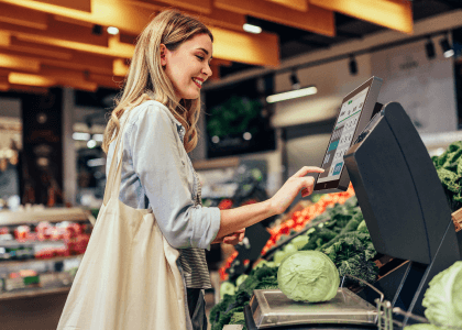 a person touches the screen of the weighing terminal running by AFL4 panel pc in a supermarket