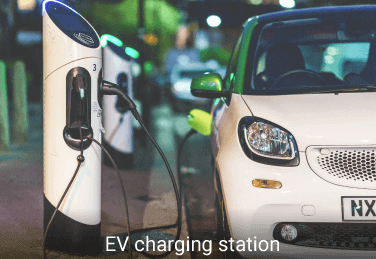 an electric car parking beside a EV charging station for vehicle charging