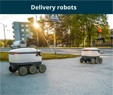 two delivery robots moving on street